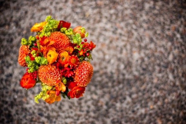 Ranunculus mixed with orange and chartreuse seasonal flowers for the 